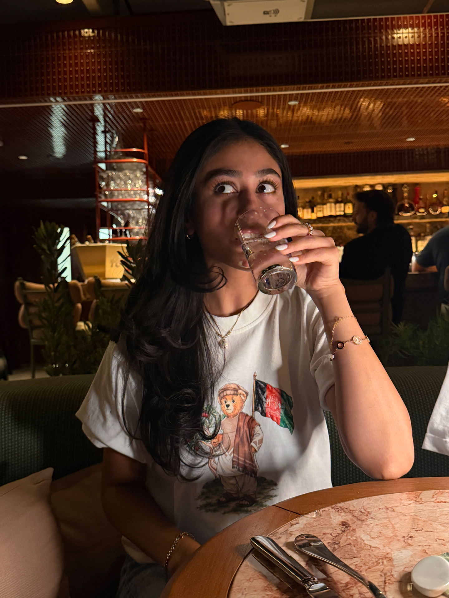 Project Paradise tee, mid-sip at the table